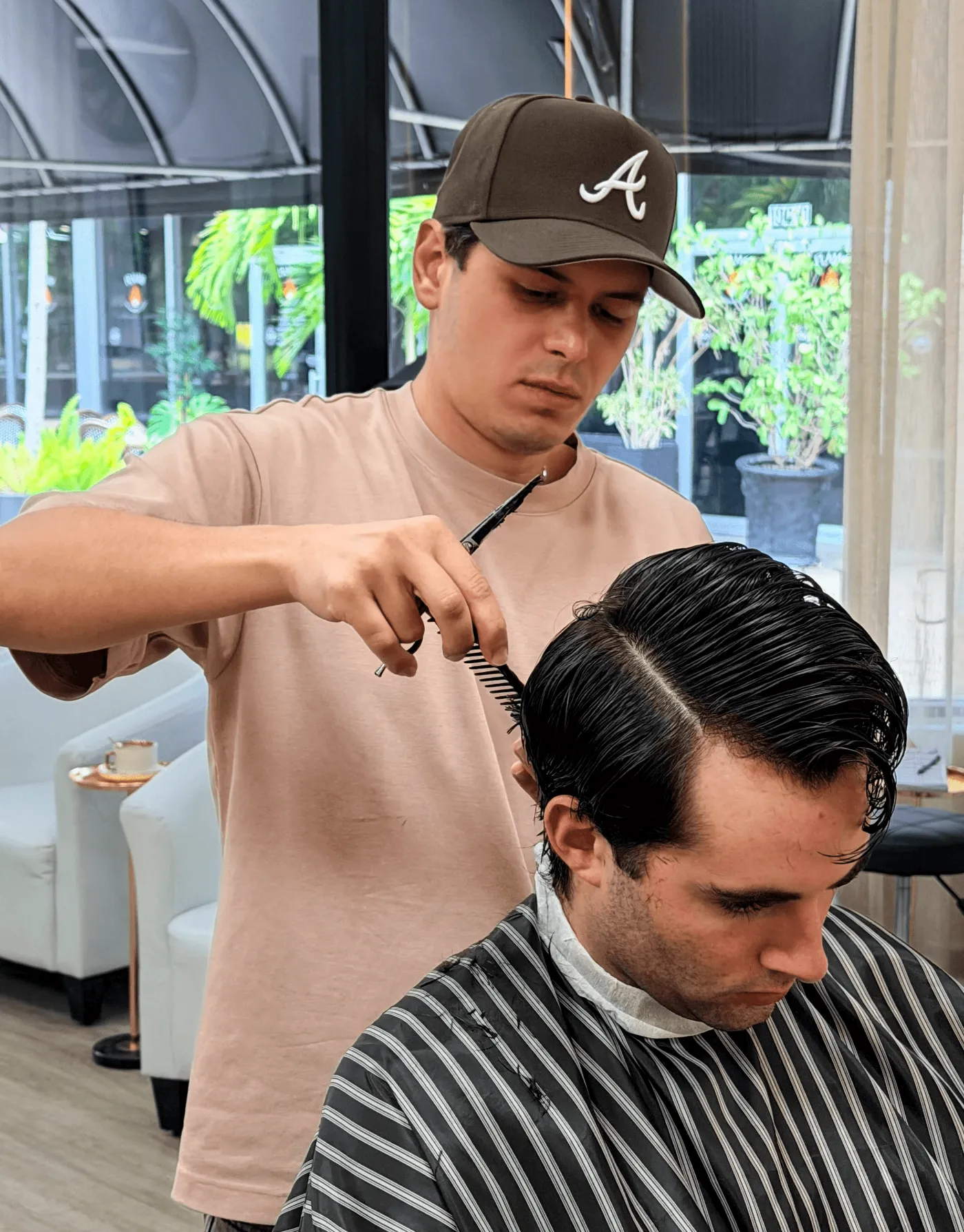 Barber cutting a client's hair at Albert K Studio